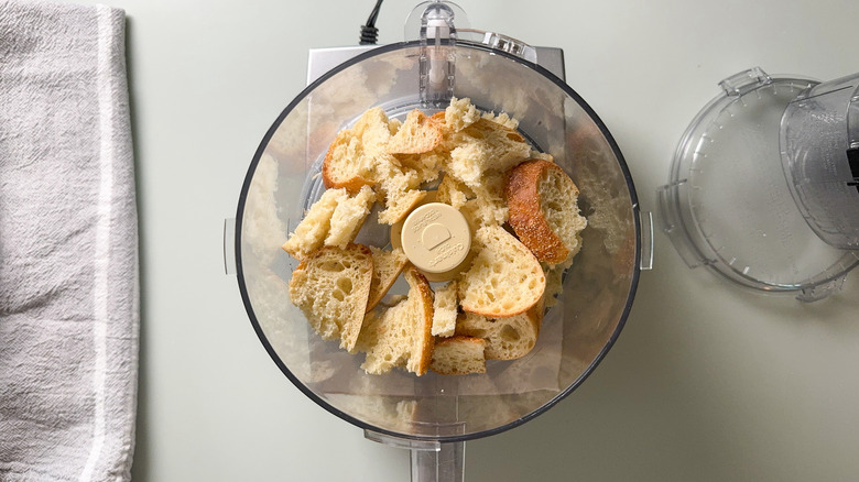 Sourdough bread pieces in bowl of food processor