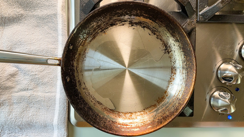 Avocado oil heating in saute pan on stovetop