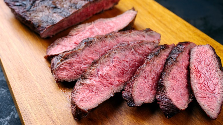 sliced bavette steak on cutting board