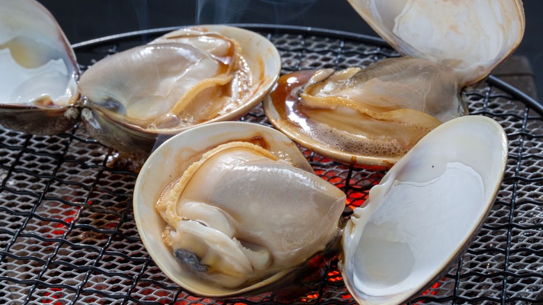 Opened clams sitting on grill