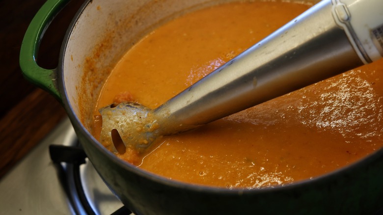 immersion blender in pot of toamto bisque