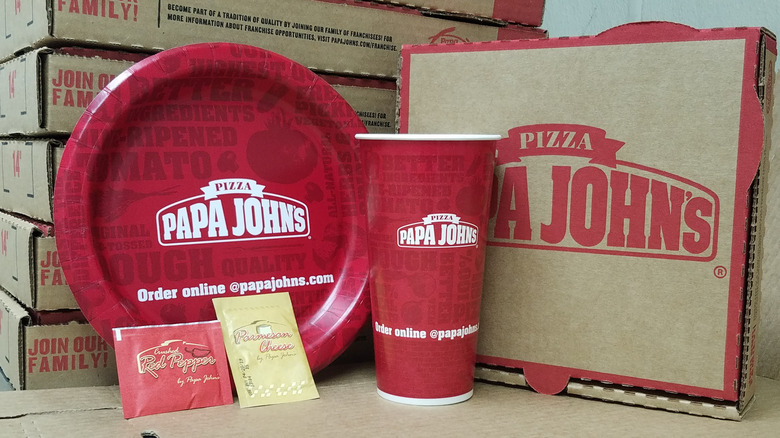 Papa John's branded cup, box, plate, and seasoning packets