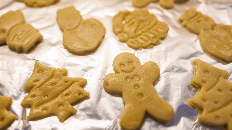 uncooked christmas cookies on foil