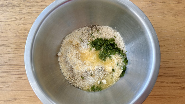 breadcrumbs and seasonings in a metal mixing bowl