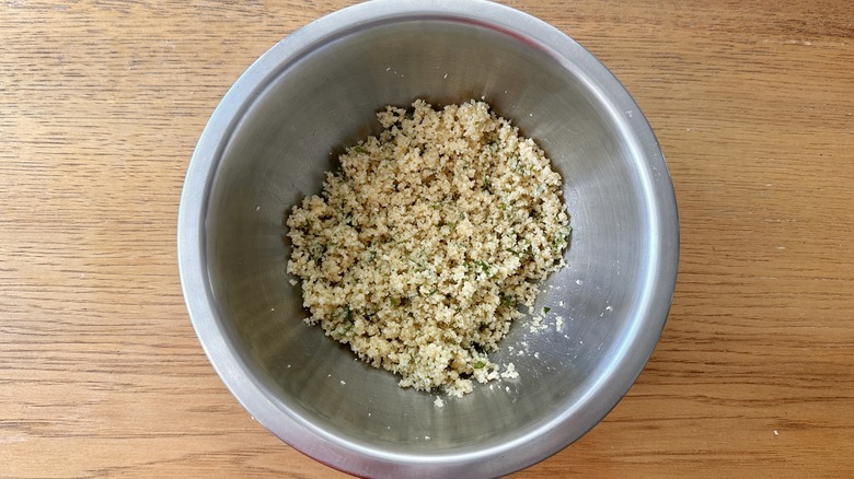 moistened breadcrumbs in a metal mixing bowl