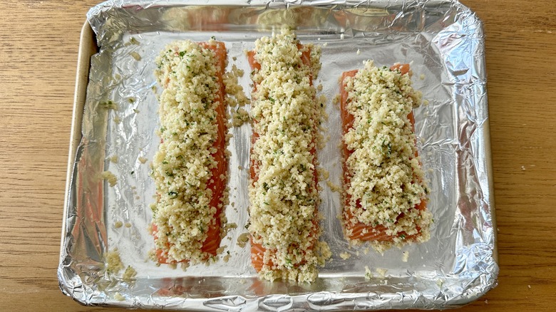 raw salmon filets covered with breadcrumbs