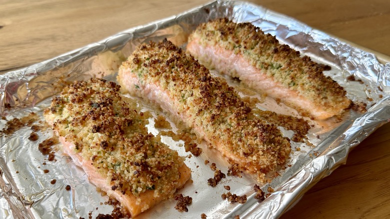 cooked salmon filets on a foil-lined baking pan