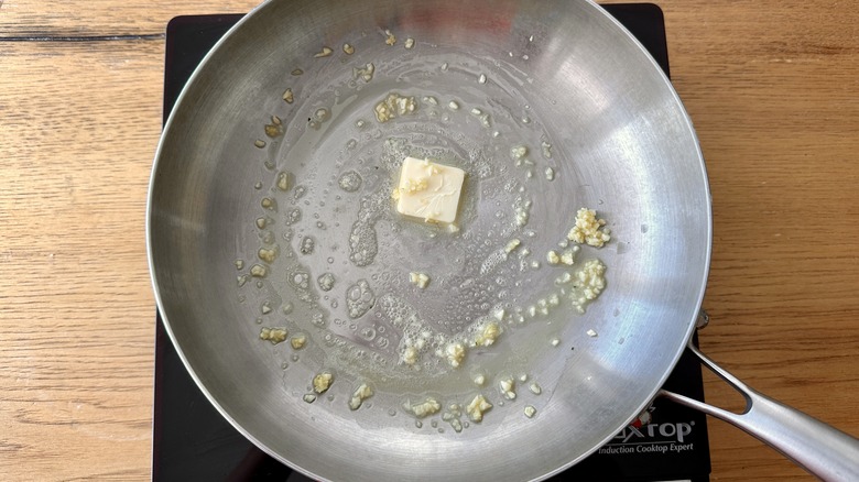 garlic and melted butter in a metal frying pan