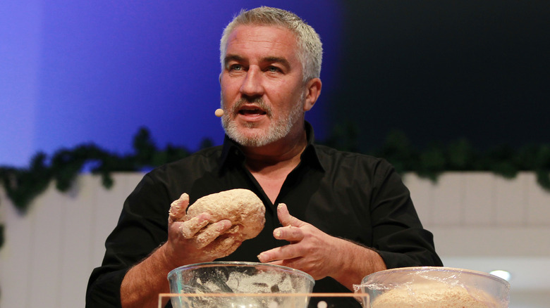 Paul Hollywood holding dough on stage