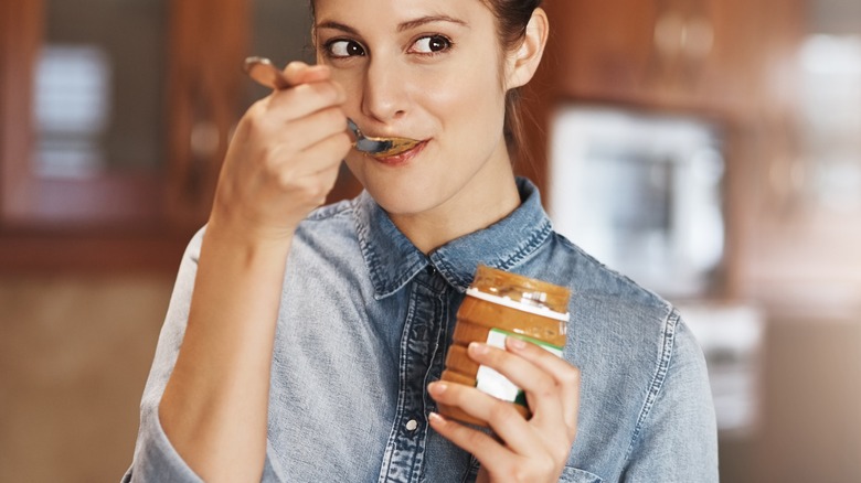 Woman eating peanut butter