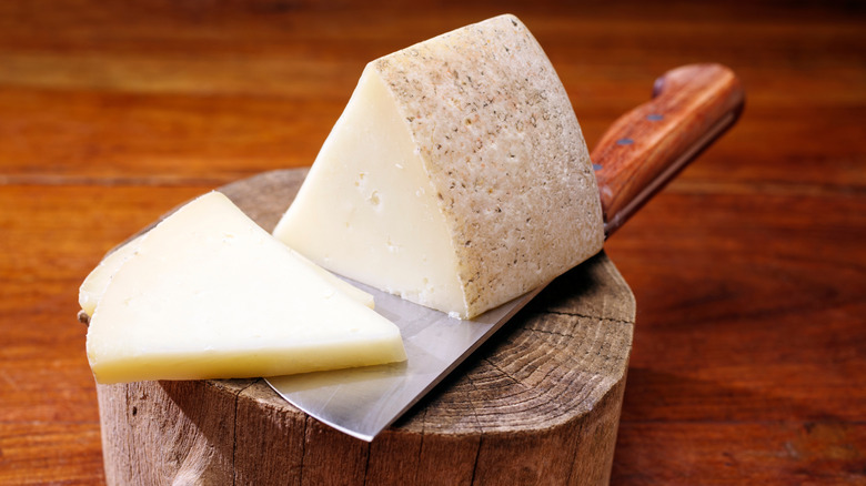 Sliced pecorino on a wooden board.