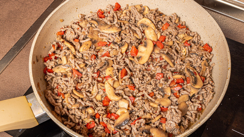 meat mushroom mixture in pan