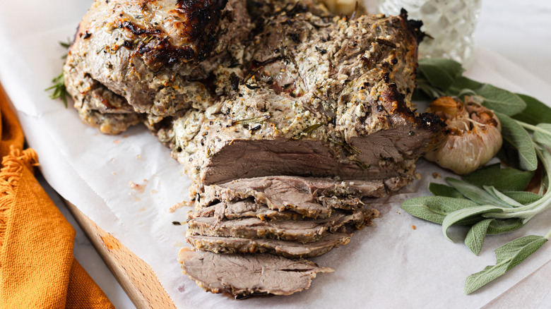 Roasted leg of lamb, sliced at the end, with sage and sauce
