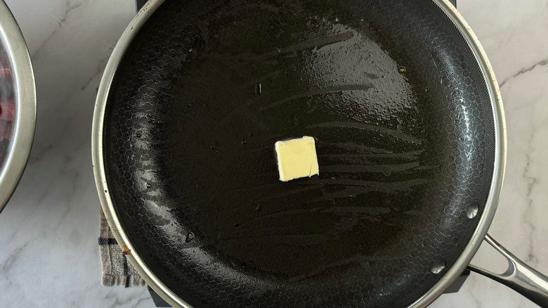 butter in black frying pan