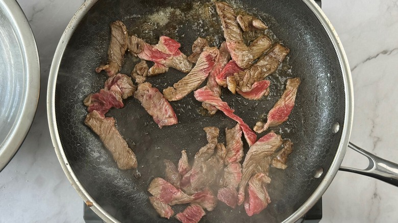 steak strips in frying pan