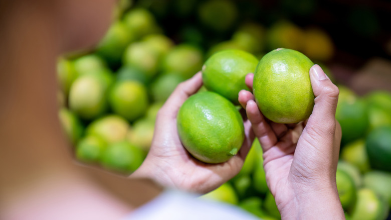 woman examining different limes 