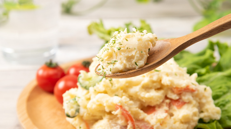 Potato salad on wooden spoon