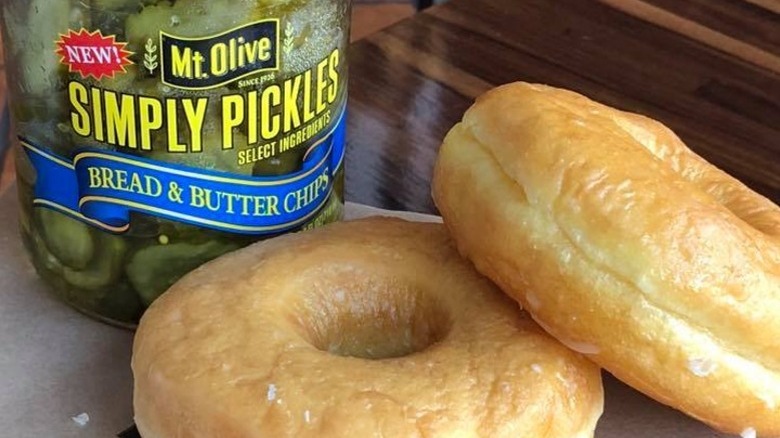 Hurts Donut Co. pickle donuts next to a jar or Mt. Olive Bread & Butter Chips pickles
