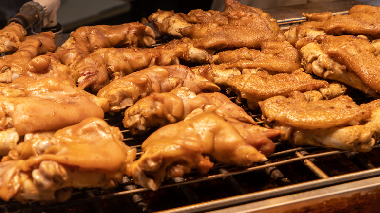 Pigs feet cooking on the grill