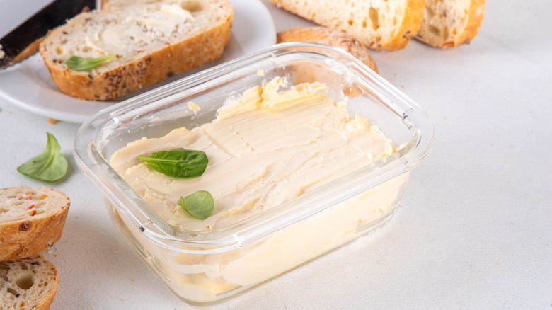 A glass container filled with plant butter.