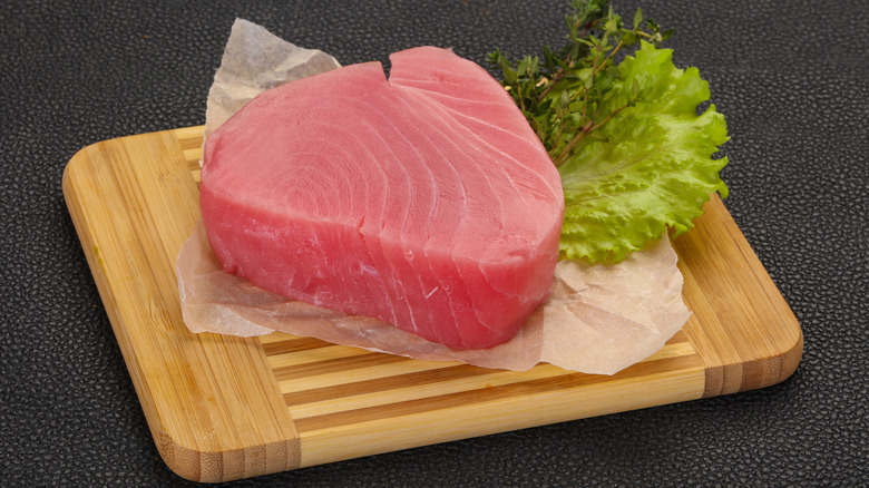 A fresh yellowfin tuna steak on cutting board