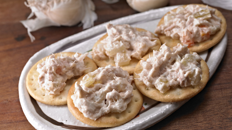 A plate of crackers topped with tuna salad