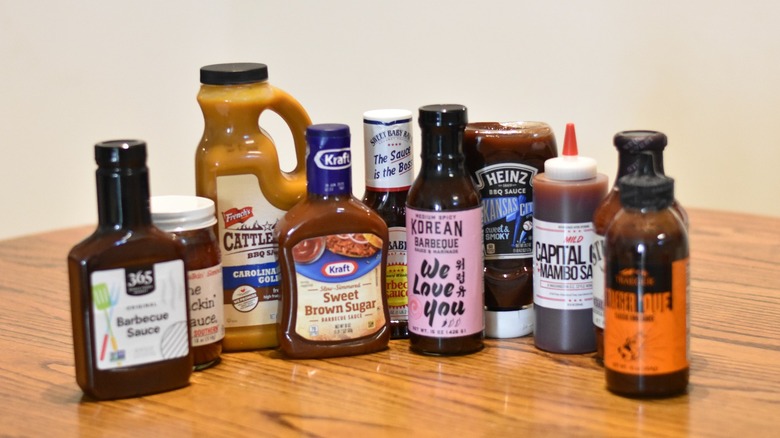 A collection of popular Amazon barbecue sauces on a wooden table