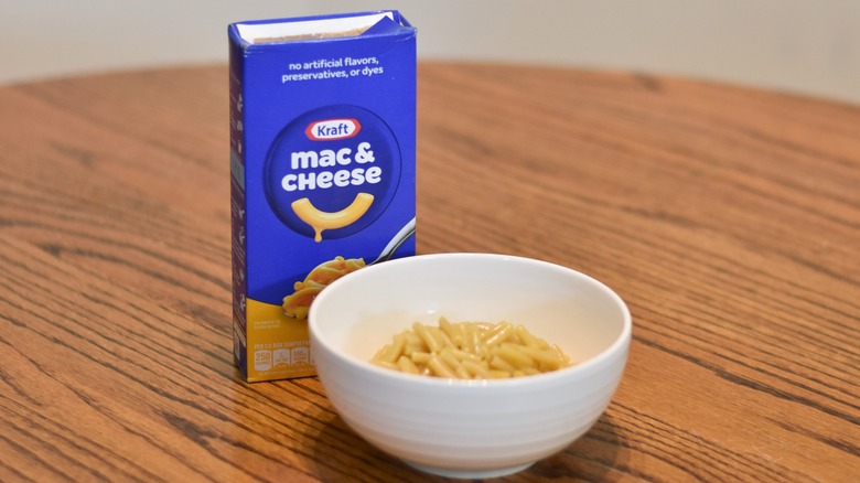 A Kraft mac and cheese box next to a bowl of macaroni