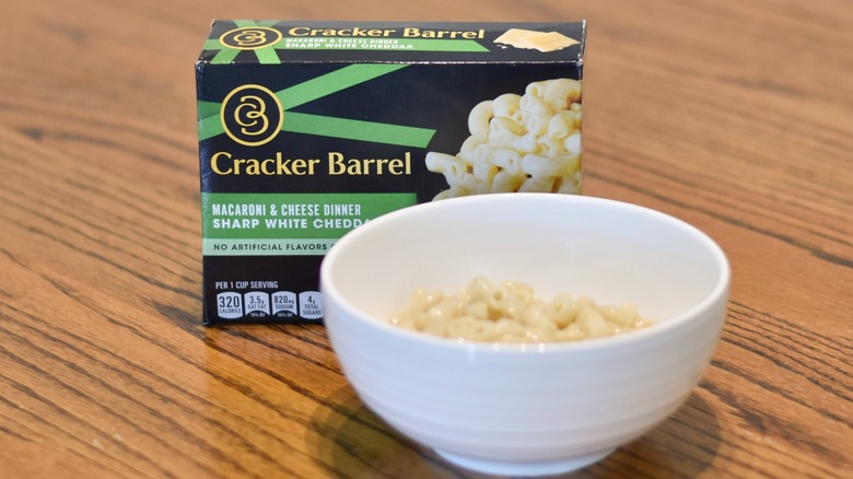 A box of Cracker Barrel mac and cheese next to a white bowl