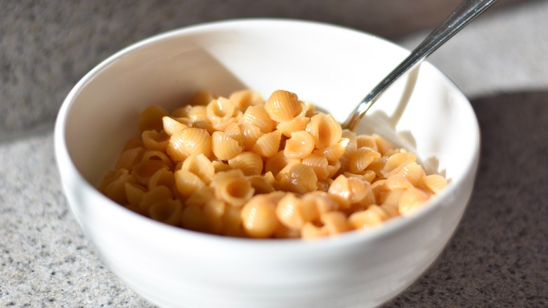 Prepared shells and cheese in a white bowl