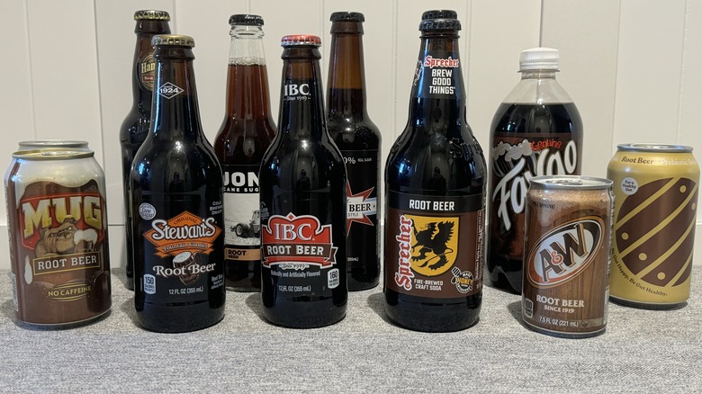 assortment of bottles and cans of root beer