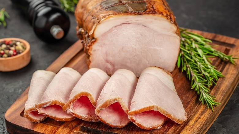 sliced smoked pork loin on a wooden tray