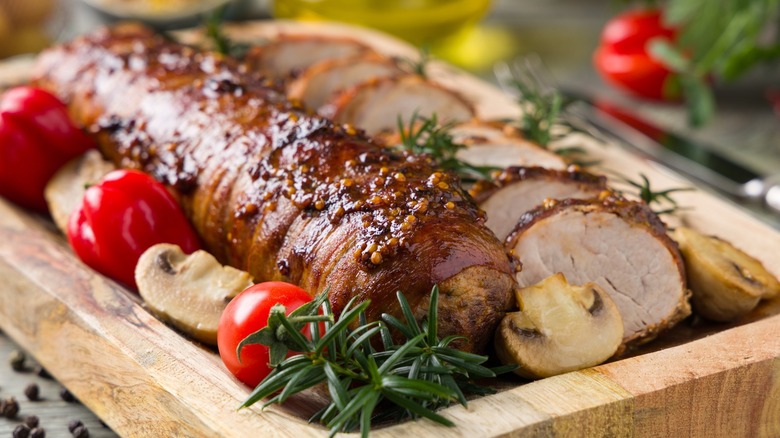 Pork tenderloin and roasted vegetables on a platter