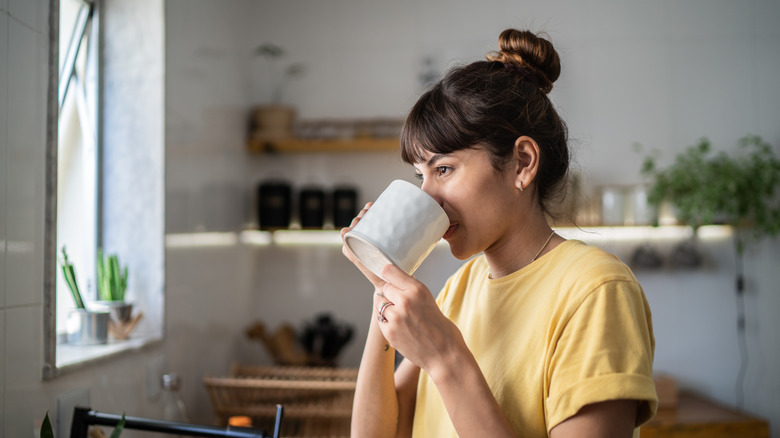 Woman drinking mug of coffee