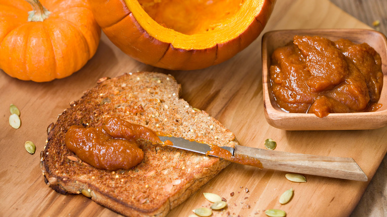 Bread being slathered with pumpkin butter