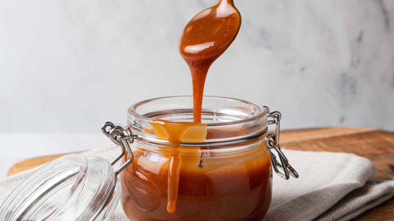 Caramel dripping in a jar