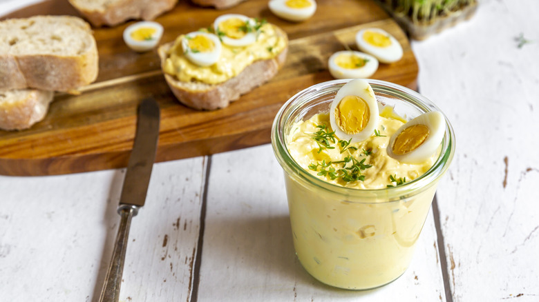 Jar of egg salad with garnish