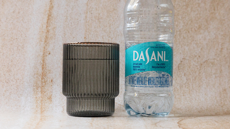 Bottle of Dasani and glass cup