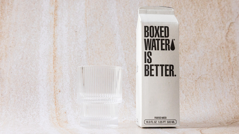 Package of Boxed Water and glass cup