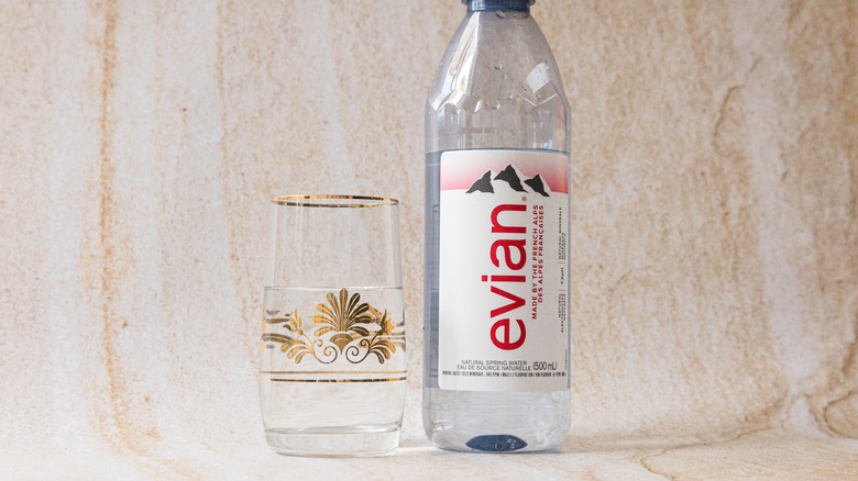 Bottle of Evian and glass cup