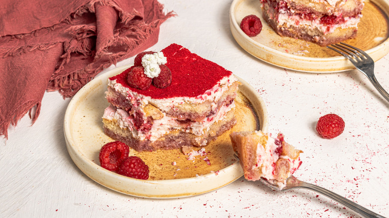 Tiramisu slice on a plate with a piece on a fork