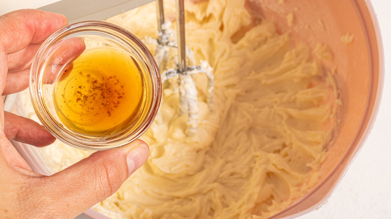 Adding vanilla extract to a bowl with mascarpone