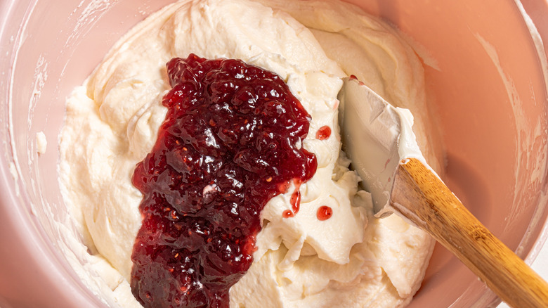 Rasperry jam on top of mascarpone cream inside a bowl