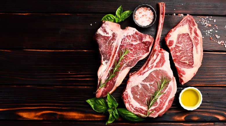 Overhead shot of raw steaks on wooden board