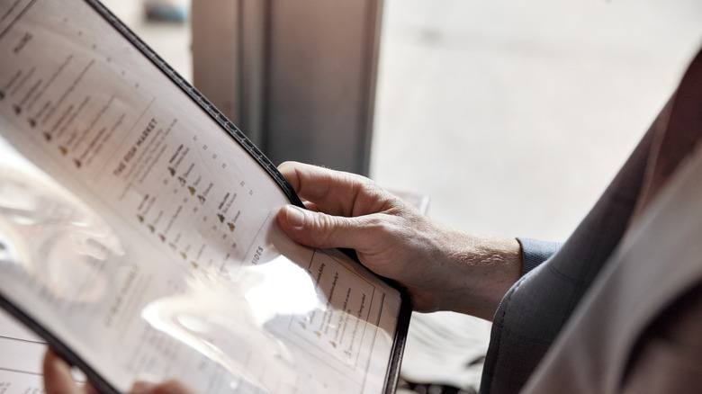 Diner examining a restaurant menu