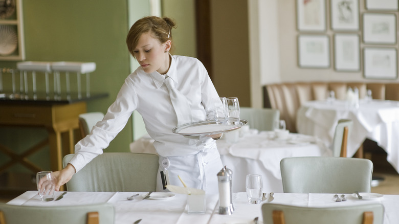 Restaurant server setting a table