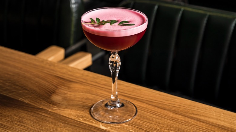 Cocktail topped with red wine foam in coupe glass