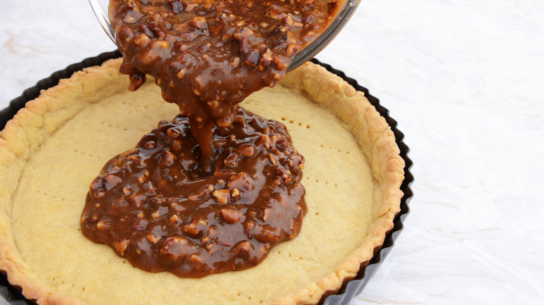 pouring pecan pie filling