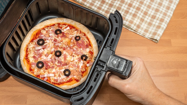 sliding pizza into air fryer