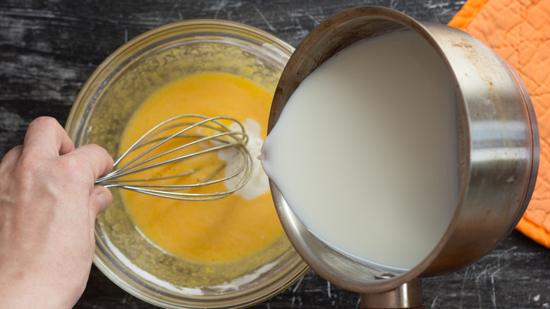 pouring cream into egg yolk mixture